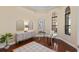 Cozy office space featuring a glass desk, decorative mirrors, and hardwood floors at 3769 Caledonia Ln, Sarasota, FL 34240