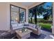 Outdoor sitting area with wicker furniture and views of the landscaped yard at 3769 Caledonia Ln, Sarasota, FL 34240