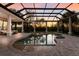 Screened-in pool area with integrated spa and ample patio space at 3769 Caledonia Ln, Sarasota, FL 34240