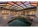 Screened-in pool with integrated spa and brick patio offers a tranquil outdoor retreat, perfect for relaxation and entertaining at 3769 Caledonia Ln, Sarasota, FL 34240