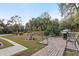 Landscaped backyard with brick patio and grill area at 4801 Brickell Dr, North Port, FL 34286