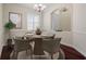 Formal dining room with hardwood floors, a wooden table, and virtually staged decor at 4801 Brickell Dr, North Port, FL 34286