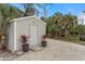 Large storage shed in the backyard with gravel driveway at 4801 Brickell Dr, North Port, FL 34286