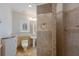 Modern bathroom with pedestal sink, tiled shower, decorative tiled floors, and a window with shutters at 4946 Brywill Cir, Sarasota, FL 34234