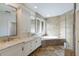 Luxurious bathroom with dual vanities, a soaking tub, and a separate glass-enclosed shower at 4946 Brywill Cir, Sarasota, FL 34234