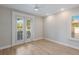 Bedroom with wood floors and natural light from a large window with shutters at 4946 Brywill Cir, Sarasota, FL 34234