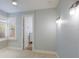 Bright bedroom with light-blue walls featuring large window with shutter, and doorway to en suite bathroom at 4946 Brywill Cir, Sarasota, FL 34234