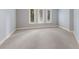 Bright bedroom featuring neutral carpet, three windows with shutters, and natural light at 4946 Brywill Cir, Sarasota, FL 34234