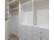 Walk-in closet with built-in shelving and drawers for organized storage at 4946 Brywill Cir, Sarasota, FL 34234