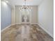 Bright dining room with modern chandelier, tile floors, and shuttered doors at 4946 Brywill Cir, Sarasota, FL 34234