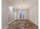 Bright dining room featuring tile floors, contemporary chandelier, and doors leading to the outside at 4946 Brywill Cir, Sarasota, FL 34234