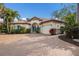 Beautiful home showcasing a paved driveway, clay tile roof, manicured landscaping, and an attached two-car garage at 4946 Brywill Cir, Sarasota, FL 34234