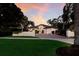 Stunning exterior elevation of a house with lush landscaping and brick driveway at 4946 Brywill Cir, Sarasota, FL 34234