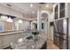 Open kitchen with stainless steel refrigerator, granite countertops, and modern fixtures at 4946 Brywill Cir, Sarasota, FL 34234