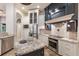 Chef's kitchen with custom cabinetry, stainless steel appliances, and a center island with granite countertop at 4946 Brywill Cir, Sarasota, FL 34234