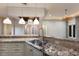 Spacious kitchen featuring a stainless steel sink and granite countertops with pendant lighting at 4946 Brywill Cir, Sarasota, FL 34234