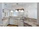 Stylish kitchen featuring granite countertops, stainless sink, and custom cabinetry at 4946 Brywill Cir, Sarasota, FL 34234