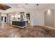 Open-concept living space with travertine floors and elegant light fixtures at 4946 Brywill Cir, Sarasota, FL 34234