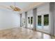 Inviting open-concept living space with travertine floors, custom lighting, neutral walls, and access to outdoor patios at 4946 Brywill Cir, Sarasota, FL 34234