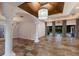 Elegant living room with tile floors, coffered ceiling, chandelier, and views of the pool area at 4946 Brywill Cir, Sarasota, FL 34234