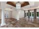 Spacious living room features tile floors, high ceilings, pillars, and a view of the backyard at 4946 Brywill Cir, Sarasota, FL 34234