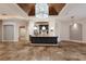 Expansive living room features tile flooring, an island with bar seating, and custom lighting at 4946 Brywill Cir, Sarasota, FL 34234