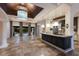 Open floor plan with kitchen and living area, tile floors, island, and view of the pool at 4946 Brywill Cir, Sarasota, FL 34234