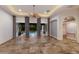 Spacious living room with tile floors, a ceiling fan, and French doors leading to the pool area at 4946 Brywill Cir, Sarasota, FL 34234