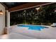 Inviting pool surrounded by lush landscaping and a covered patio at 4946 Brywill Cir, Sarasota, FL 34234