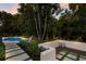 Backyard pool and seating area surrounded by lush landscaping, creating a private and relaxing outdoor space at 4946 Brywill Cir, Sarasota, FL 34234