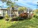 Lush green backyard featuring a spacious screened enclosure at 5115 44Th St W, Bradenton, FL 34210