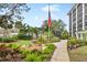 Well-manicured community garden with flag and fountain at 512 W Venice Ave # 401, Venice, FL 34285