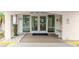 Condo building entrance with double doors and seating at 512 W Venice Ave # 401, Venice, FL 34285