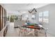 Bright dining room with round wooden table and four chairs, view into living room and kitchen at 512 W Venice Ave # 401, Venice, FL 34285
