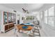 Bright dining room with round wooden table and four chairs, view into living room and kitchen at 512 W Venice Ave # 401, Venice, FL 34285