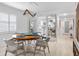 Bright dining room with round wooden table and four chairs, view into kitchen and hallway at 512 W Venice Ave # 401, Venice, FL 34285