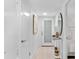Light hallway with white walls, wood flooring, and a frosted glass door at 512 W Venice Ave # 401, Venice, FL 34285