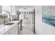 Modern white kitchen with stainless steel appliances and ample cabinetry at 512 W Venice Ave # 401, Venice, FL 34285