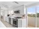 Modern kitchen with stainless steel appliances and breakfast bar at 512 W Venice Ave # 401, Venice, FL 34285