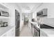 Bright, galley-style kitchen, featuring stainless steel appliances at 512 W Venice Ave # 401, Venice, FL 34285
