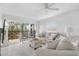 Spacious living room with light beige sofa and chairs, sliding glass doors to balcony at 512 W Venice Ave # 401, Venice, FL 34285