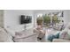 Living room with a large TV, comfortable seating and sliding glass doors leading to a balcony at 512 W Venice Ave # 401, Venice, FL 34285