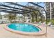 Inviting community pool with screened enclosure and lounge chairs at 512 W Venice Ave # 401, Venice, FL 34285