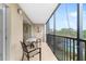 Relaxing screened balcony with table and chairs at 512 W Venice Ave # 401, Venice, FL 34285