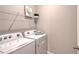 Laundry room with washer, dryer, and wire shelving at 5509 Coachwood Cv, Bradenton, FL 34211