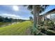 Landscaped backyard with pond view and lush greenery at 5846 Cavano Dr, Sarasota, FL 34231