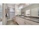 Clean bathroom with granite countertop, white cabinets, and a bathtub at 5846 Cavano Dr, Sarasota, FL 34231