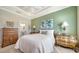 Bedroom with green accent wall and wood furniture at 5846 Cavano Dr, Sarasota, FL 34231