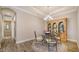 Bright dining room with glass table and wooden hutch at 5846 Cavano Dr, Sarasota, FL 34231