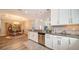 Open kitchen with white cabinets, granite counters, and breakfast nook at 5846 Cavano Dr, Sarasota, FL 34231